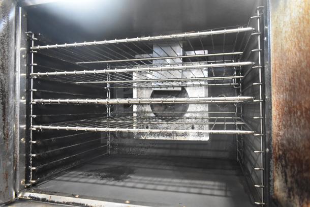Royal full-size commercial convection oven interior with multiple racks, view-through door, on commercial casters.