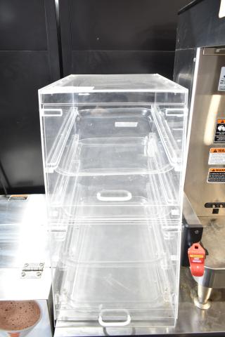 Clear poly dry display case merchandiser, transparent shelves, good condition, ideal for showcasing bakery items.