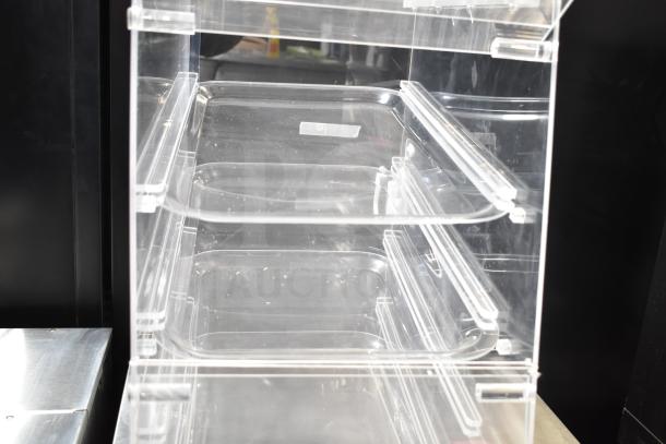 Clear poly dry display case merchandiser, shows interior shelving, good condition, ideal for food or product showcasing.