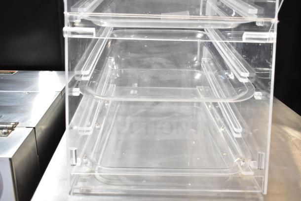 Clear poly dry display case merchandiser with two shelves, transparent design. Ideal for showcasing products in pristine condition.