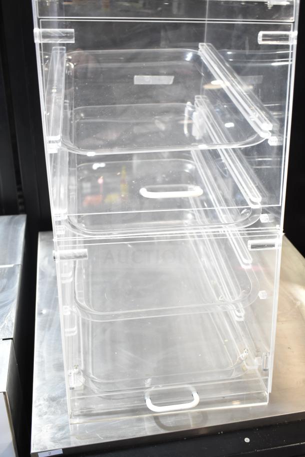 Clear poly dry display case merchandiser with multiple shelves, transparent design, and front handles, ideal for displaying goods.