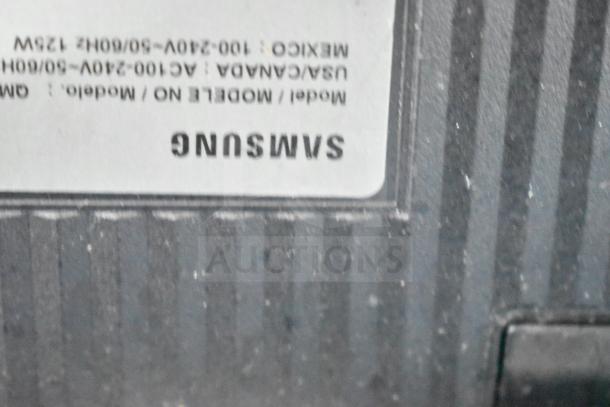 Back view of a Samsung television with a visible label showing power specifications for various regions.