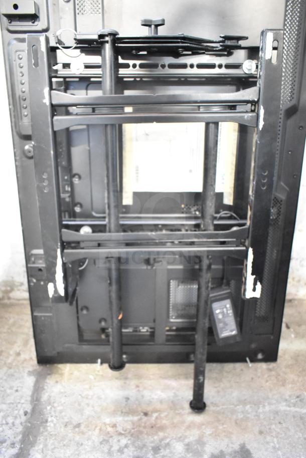 Pair of NEC V463 TVs with wall mounts, showing back view; buyer must pick up.