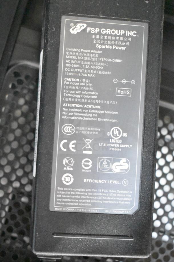 Label on power adapter showing "FSP Group Inc." branding and model number FSP090-DMBB1. Includes voltage and efficiency details.