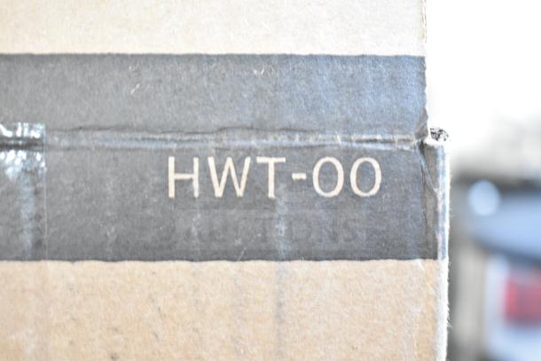 Cardboard box labeled "HWT-00" for Insinkerator Instant Hot Water Tank, scratch and dent condition.