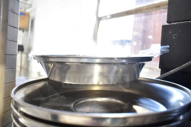 Metal dome covers, stack of 40, stainless steel, polished finish. Protective film visible. Auction offers 40 times bid.