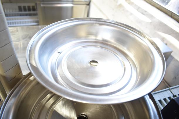 Stack of metal dome covers, smooth finish, shiny condition, quantity 40, ideal for catering use.