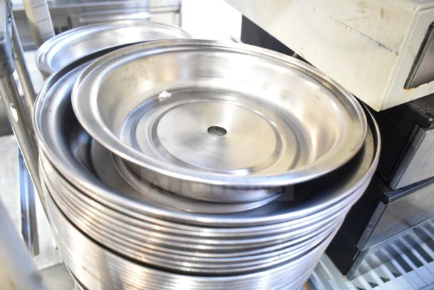 Stack of 40 silver metal dome covers in used condition, ideal for food service, with a central hole for steam release.