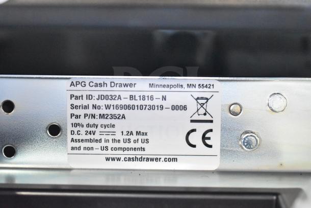 APG cash drawer label showing Part ID JD032A, Serial No. W1690601073019-0006, 24V, CE Mark, assembled in the US.