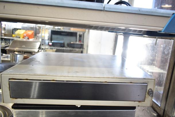 5 various cash drawers stacked; metal exterior, key lock visible, used condition, minor surface wear.