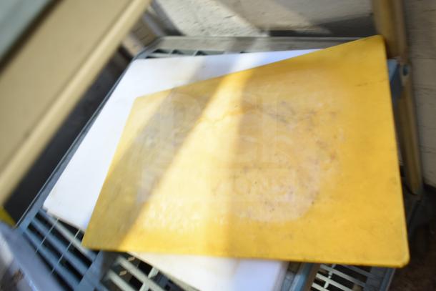 Four cutting boards stacked; one is yellow. Appears used. Bundle increases bid by four times.