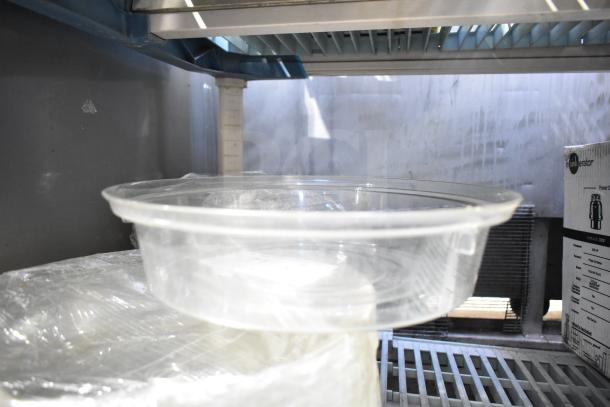 Clear poly dome cover, stack of 20, transparent, unused condition. Ideal for food storage or display, durable material.