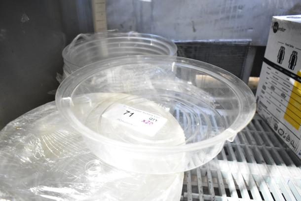 20 clear poly dome covers, unused. Includes auction tag indicating quantity of 20. Great for protective use.