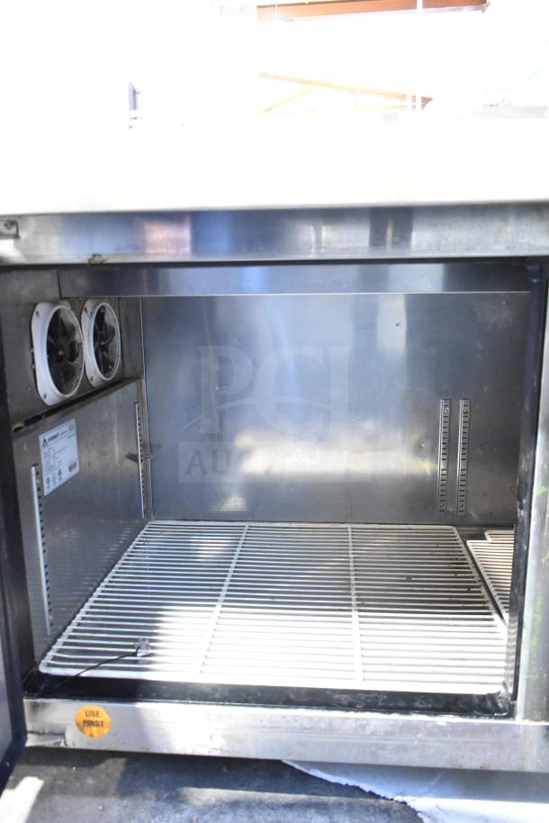 Everest EPPSR2 commercial pizza prep table with two-tier overshelf, 115 volts, 1 phase, stainless steel interior, visible shelving.