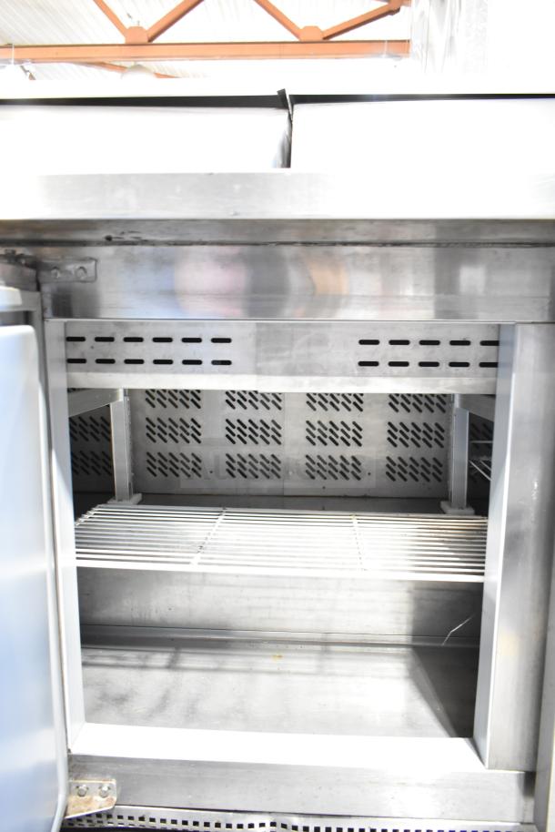 Berg EDMT-72-30 commercial sandwich salad prep table, stainless steel, interior view, shelving, 115 volts, 1 phase.