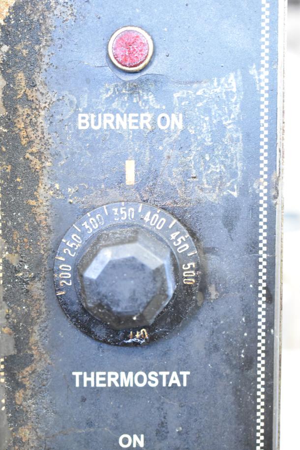 Close-up of the Royal RCOS-1 oven thermostat control with temperature range 200-500°F and "Burner On" indicator.