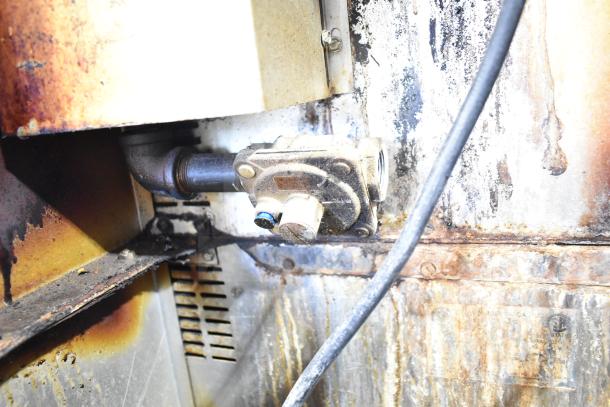 Royal RCOS-1 commercial convection oven detail, showing natural gas connection and wear on metal surface.