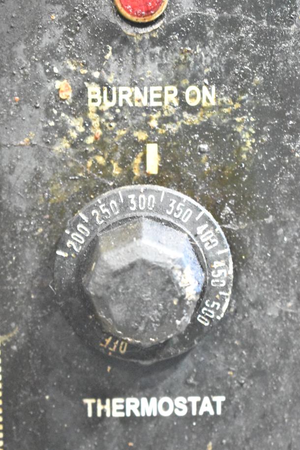 Close-up of the Royal RCOS-1 convection oven's thermostat dial. Visible temperature markings and "BURNER ON" indicator.