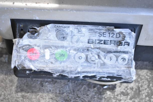 Bizerba SE 12 D commercial meat slicer, showing worn control panel with visible labels for operation and functions.