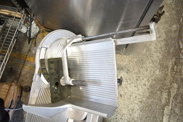 Bizerba SE 12 D commercial meat slicer, 120 volts, 1 phase, in used condition, with visible slicing blade and handle adjustments.