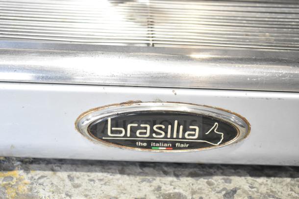 Brasilia OPUS-R-D-2 espresso machine label, displays brand name. Features include 2 groups, 2 portafilters, and steam wands.