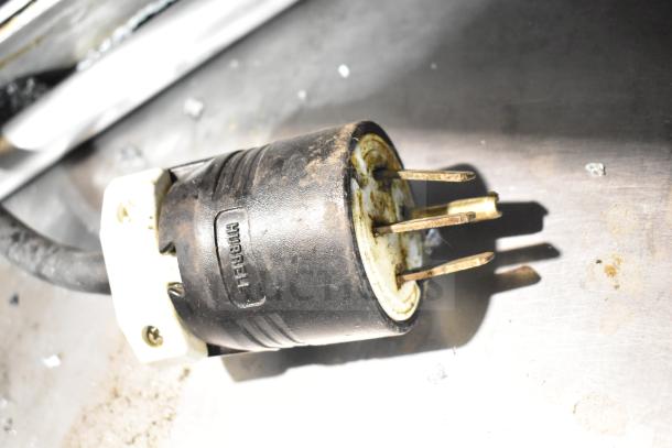 Plug of Fri-jado TDR7-P rotisserie oven showing wear. 208V, 3-phase connection. Note: broken glass on oven (not shown).