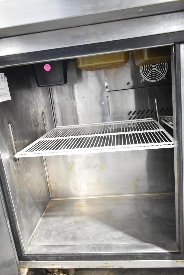 Atosa MSF8304 Commercial Prep Table, showing the interior with shelves, storage pans, and ventilation fan; used condition.