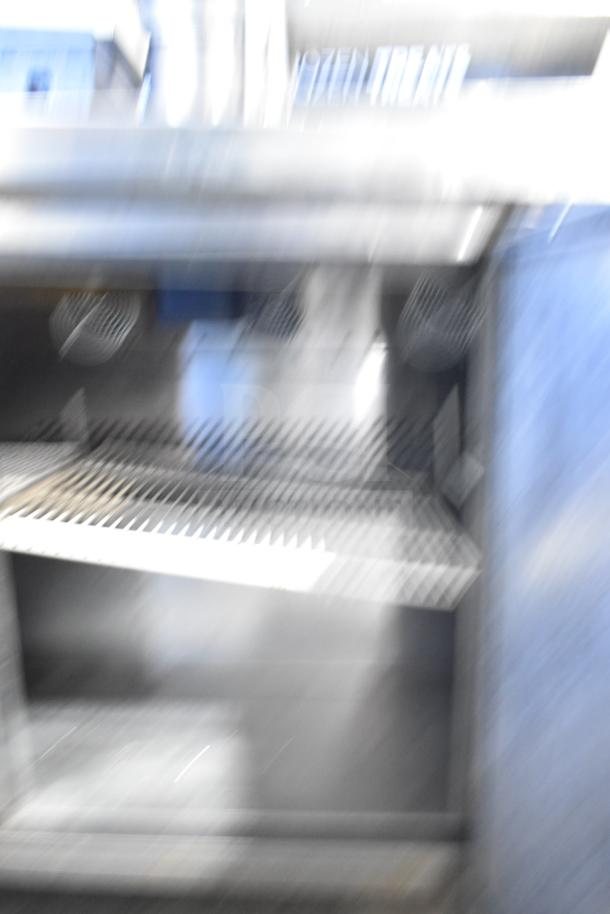 Blurry image of Atosa MSF8304 Commercial Prep Table. Stainless steel, on casters, for sandwich/salad prep. 115V, 1 phase.