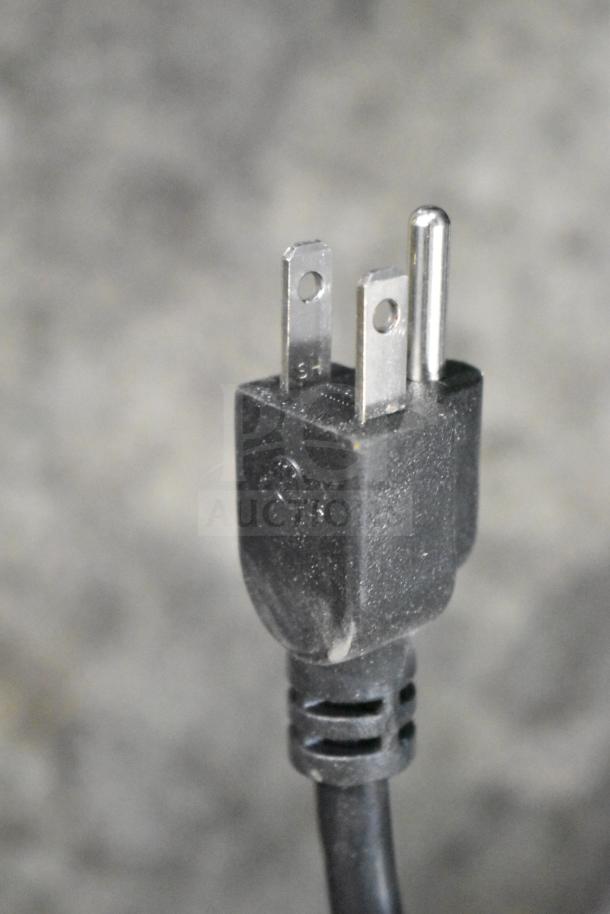 Power plug of Vevor HC-250 Commercial Bone Saw Machine, 110-120 Volts, 1 Phase. Black cord visible, close-up view.