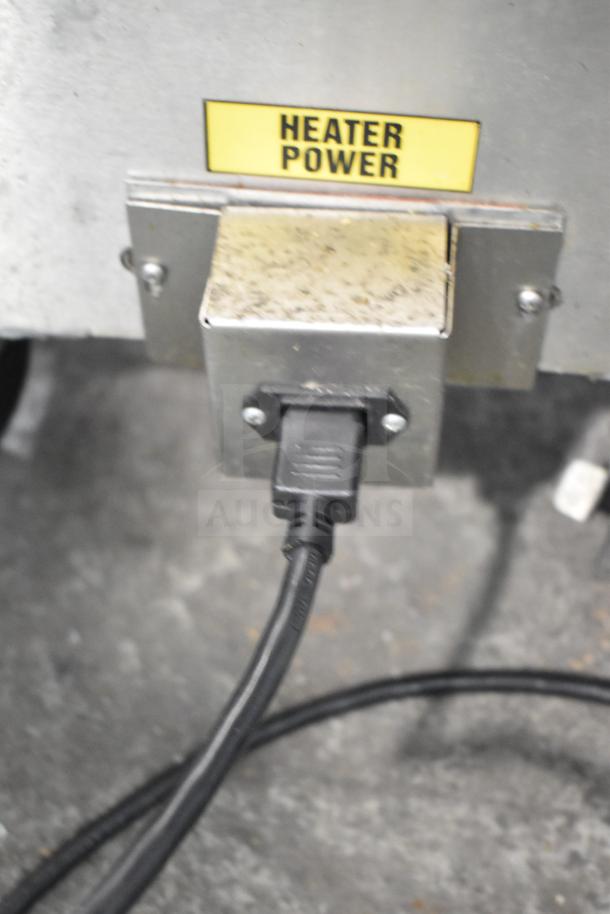 2023 Frontline 47SS Grease Caddy with heater power port, commercial casters, minor wear visible, ideal for commercial use.