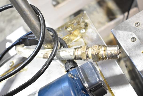 2021 Frontline 47SS Commercial Grease Caddy hose and fittings. Stainless steel with visible wear, mounted on commercial casters.