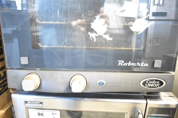 Cadco Unox XAF003 Roberta convection oven, metal, electric, 120V, 1 phase, worn exterior, labeled with brand and model.