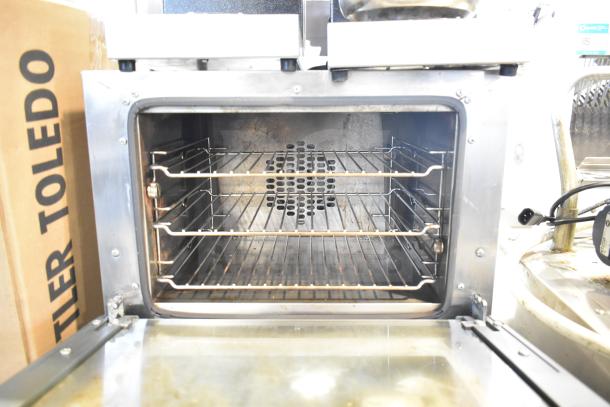 Cadco Unox XAF003 Roberta convection oven, electric-powered, countertop model, interior racks visible, 120 volts, 1 phase.