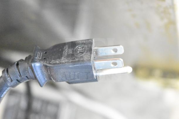 Close-up of a plug from a 2021 Sharp R-21LVF Commercial Countertop Microwave Oven, indicating 120 Volts, 1 Phase.