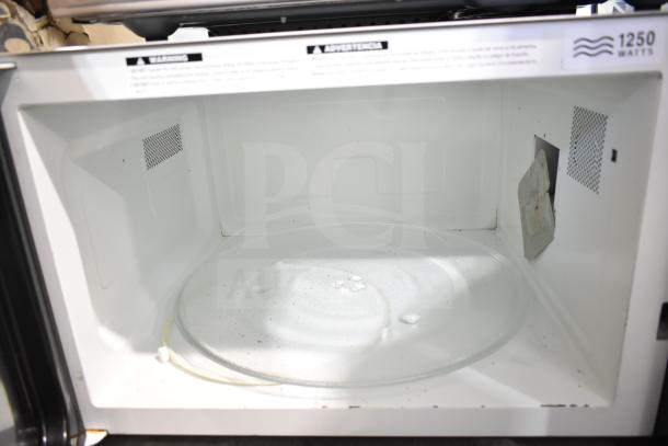2021 Panasonic NN-T945SFX Countertop Microwave Oven interior, 1250 watts, with glass turntable. Condition: Used.