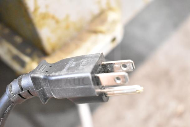 Close-up of a power plug for the 2021 Panasonic NN-T945SFX Countertop Microwave Oven, model NN-T945SFX.