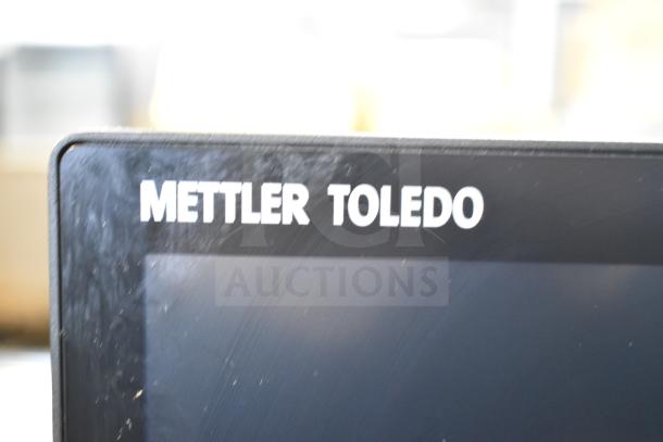 Mettler Toledo FreshWay food portioning scale screen close-up, showing logo and minor surface wear. Model for accurate weighing.