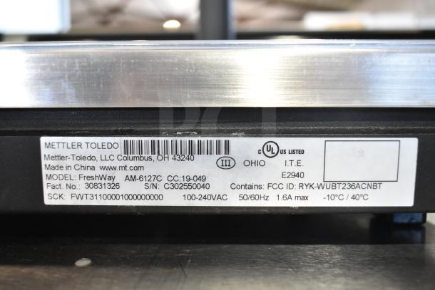 Mettler Toledo FreshWay food portioning scale label. Model AM-6127C, 100-240V, FCC ID RYK-WUBT236ACNBT. Made in China.