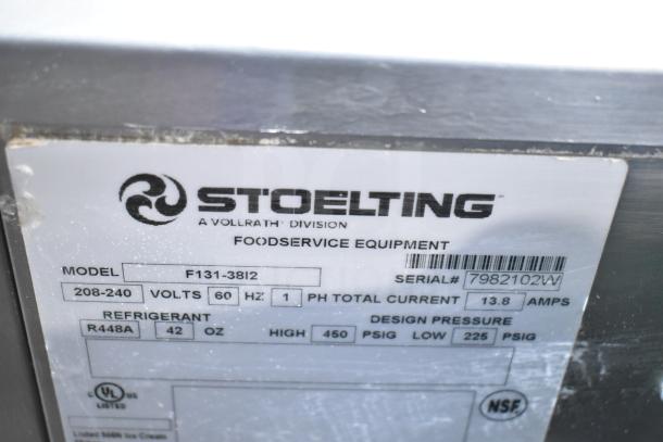 Stoelting F131-38I2 stainless steel soft serve machine label, showing model, voltage, refrigerant R448A, and serial number.
