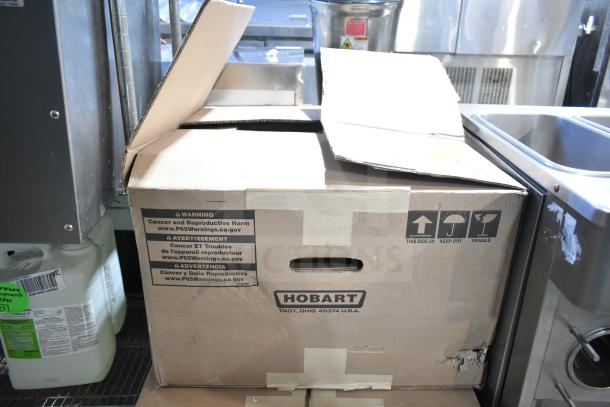 Cardboard box for 2016 Hobart HTi-7LH Commercial Countertop Food Portioning Scale, showing Hobart branding and handling instructions.