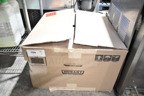 Brown cardboard box labeled "Hobart HTi-7LH26," showing shipping symbols and auction sticker "104, QTY 1".