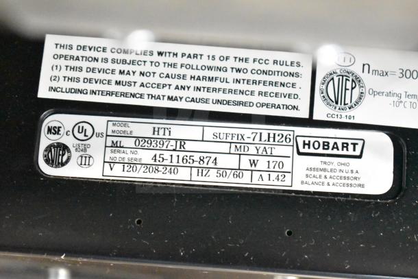 2017 Hobart HTi-7LH26 scale label showing model, serial number, voltage, wattage, and compliance details.