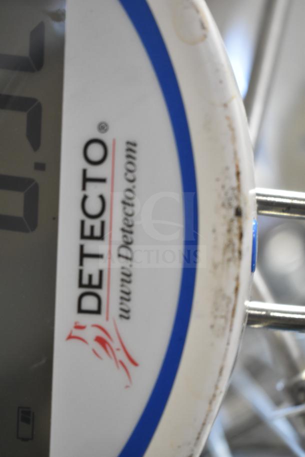 Detecto SCS30 produce scale close-up, showing logo and website. White casing with signs of wear.