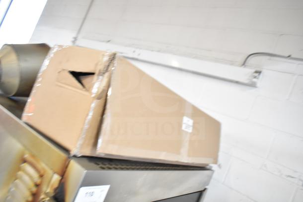 Hardt Inferno 4500 stainless steel rotisserie oven with skewers, metal legs, and commercial casters. Natural gas powered.