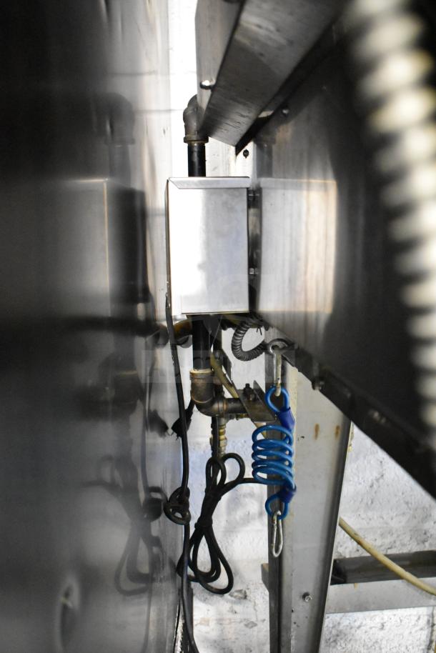 Hardt Inferno 4500 stainless steel commercial rotisserie oven, natural gas powered, with skewers, metal legs, and casters.