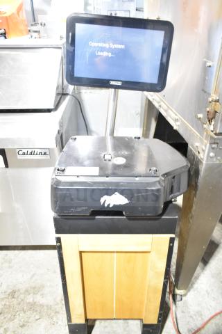 2023 Hobart HTi-SSLSC commercial food portioning scale on stand, digital screen displaying "Operating System Loading."