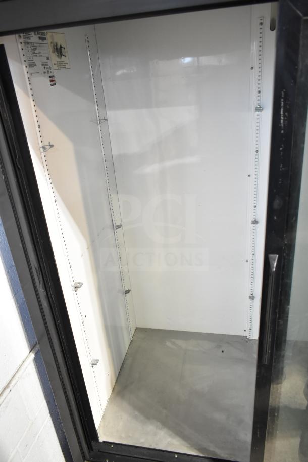 True GDM-45-LD Commercial Cooler, 2-door, reach-in, 115V, visible interior, adjustable shelving brackets, model label visible.