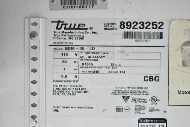 Label for True GDM-45-LD cooler, showing model, 115V, 60Hz, 1Ph specifications, and refrigerant R134A. Serial number: 8923252.