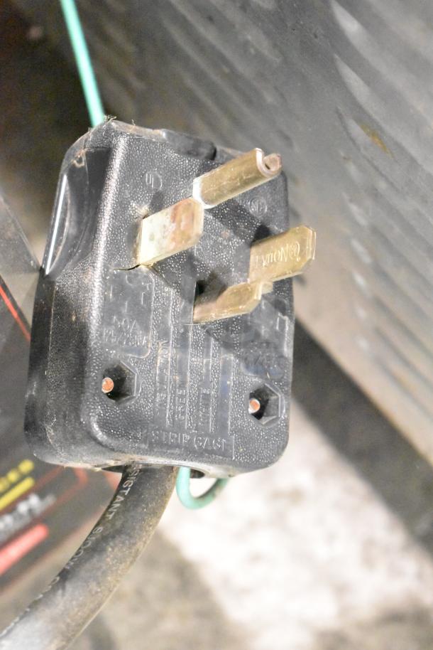 A close-up of the plug and cord for a Cecilware CL100-N commercial coffee urn. Plug shows voltage markings.