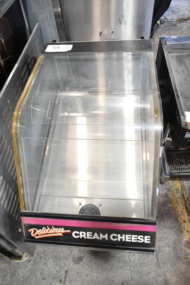Structural Concepts DD17R Refrigerated Dual Service Merchandiser, 120V, 1 Phase. Glass panels, branded "Delicious Cream Cheese."